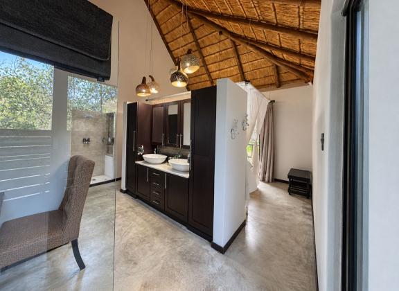 Modern Rustic Vanity Beneath a Thatched Ceiling.jpg