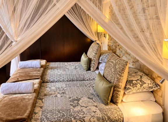 Canopy Bed in a Warm Stone Retreat.jpg